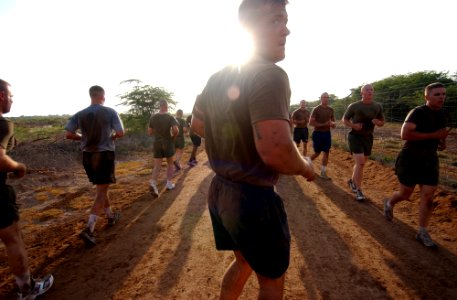 US Navy 060327-N-0411D-013 Navy Equipment Operator 3rd Class John Palmer leads early morning physical training at the Marines Corporal's Course aboard Camp Lemonier, Djibouti