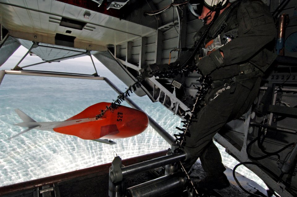 US Navy 060315-N-4374S-011 An air crewman assigned to the Blackhawks of Helicopter Mine Counter Measure Squadron One Five (HM-15), retrieves a marker float from the rear ramp of an MH-53E Sea Dragon helicopter during an MK-103