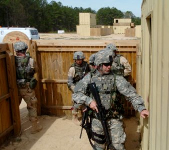 US Navy 060405-N-4097B-007 Sailors prepare to enter a simulated building while participating in the Navy's Individual Augmentee Combat Training course at Fort Jackson, S.C