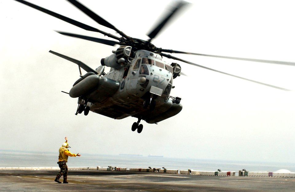 US Navy 060430-N-9866B-042 A CH-53 Super Stallion helicopter takes off from the flight deck aboard the amphibious assault ship USS Peleliu (LHA 5)