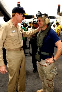 US Navy 060503-N-5174T-016 Commander, Carrier Strike group Seven, Rear Adm. Michael Miller, greets actor Gary Sinise as he arrives aboard the Nimitz-class aircraft carrier USS Ronald Reagan (CVN 76)