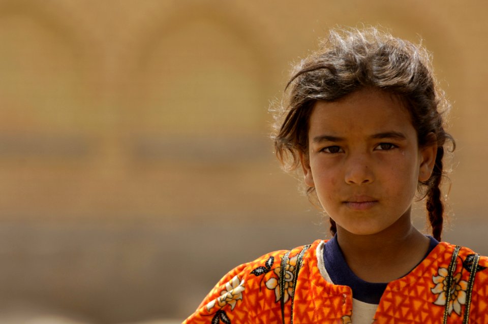 US Navy 060322-N-4614W-065 A young Iraqi girl observes military personnel talk with her family