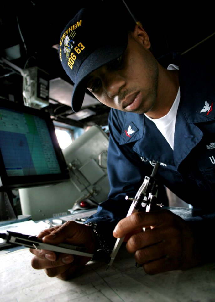 US Navy 060504-N-4953E-030 Quartermaster 3rd Class Carrin Johnson assigned to the guided-missile destroyer USS Stethem (DDG 63), plots the ship's course