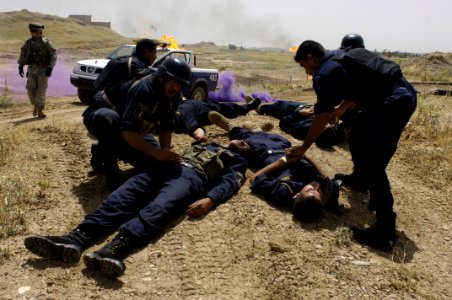 US Navy 060509-N-4614W-052 Iraqi patrol officers with the Oil Protection Force tend to a fellow officers injured by a simulated improvised explosive device during training at the Northern Oil Company compound outside Kirkuk