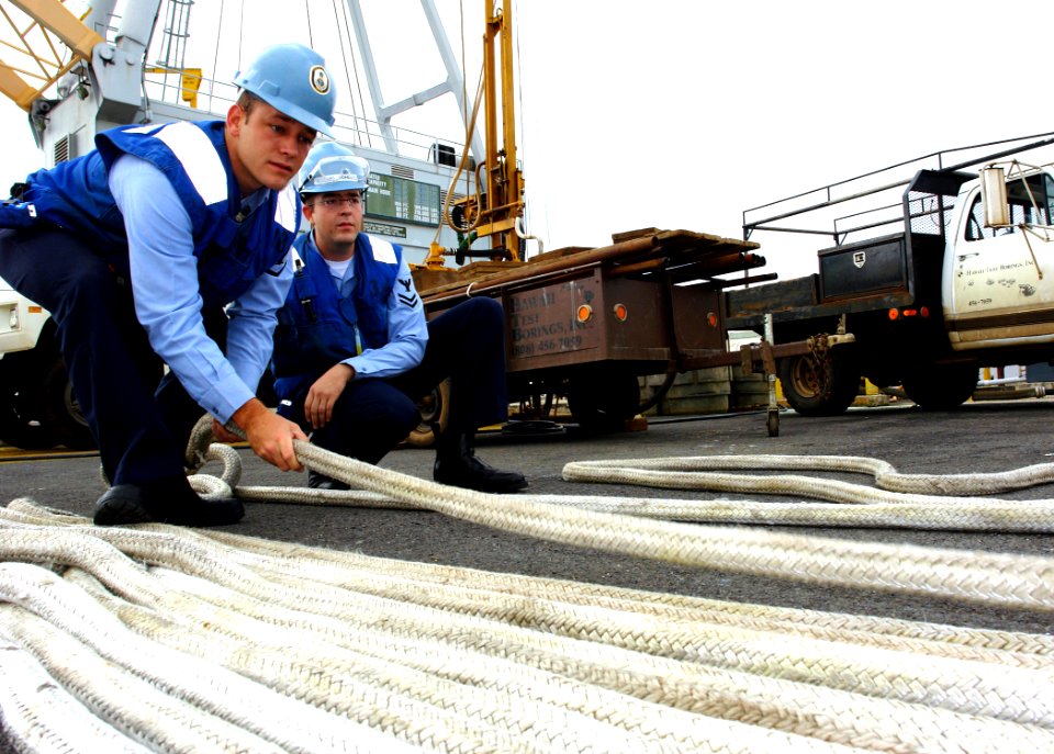 US Navy 060418-N-9643K-002 Fire Controlman 3rd Class John Bridgeman assigned to the guided-missile cruiser USS Paul Hamilton (CG 65) fakes a Kevlar mooring line as part of line handlers' duty at Pearl Harbor
