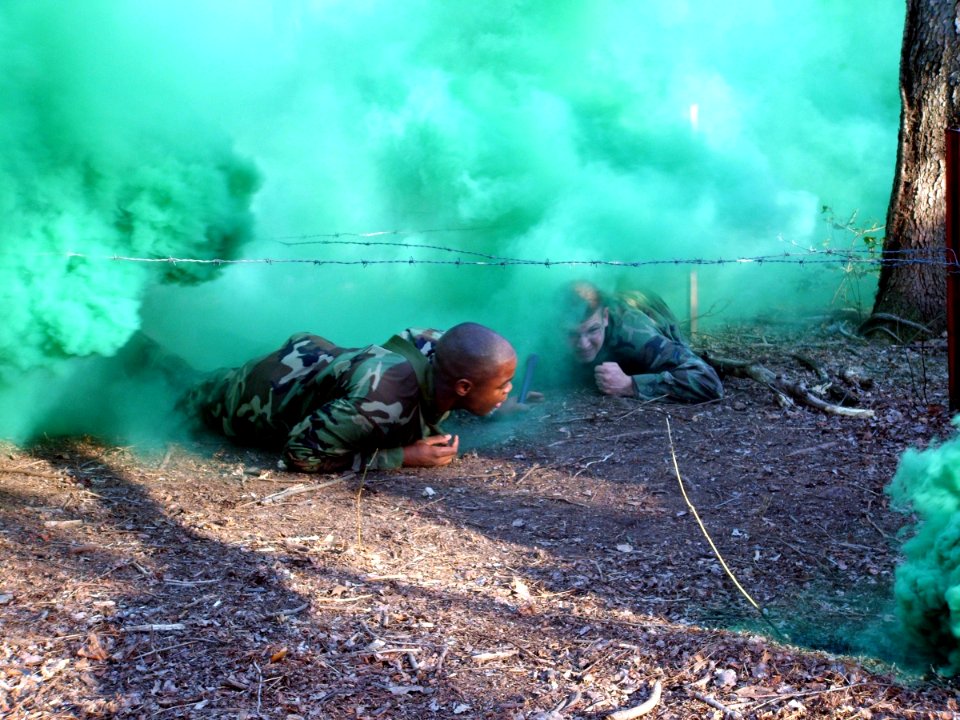US Navy 060327-F-9429S-037 U.S. Navy Master-at-Arms 2nd Class Warrne Summers and Air Force Airman 1st Class Andrew Prunitis, both students in the Air Force Phoenix Raven Class 06-D here, crawl through smoke