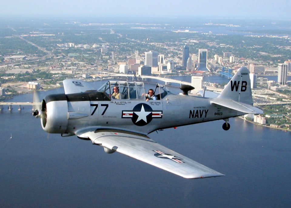 US Navy 060421-N-0000T-001 Cmdr. Mike Ginter, Operations Officer aboard USS John F. Kennedy (CV 67), raffled off a ride in his World War II T-6 Texan aircraft