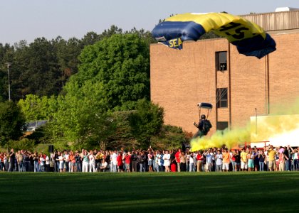 US Navy 060425-N-7517M-009 A U.S. Navy Parachute Demonstration Team member assigned to the Leap Frogs, descends at Dunwoody High School in support of Navy Week photo