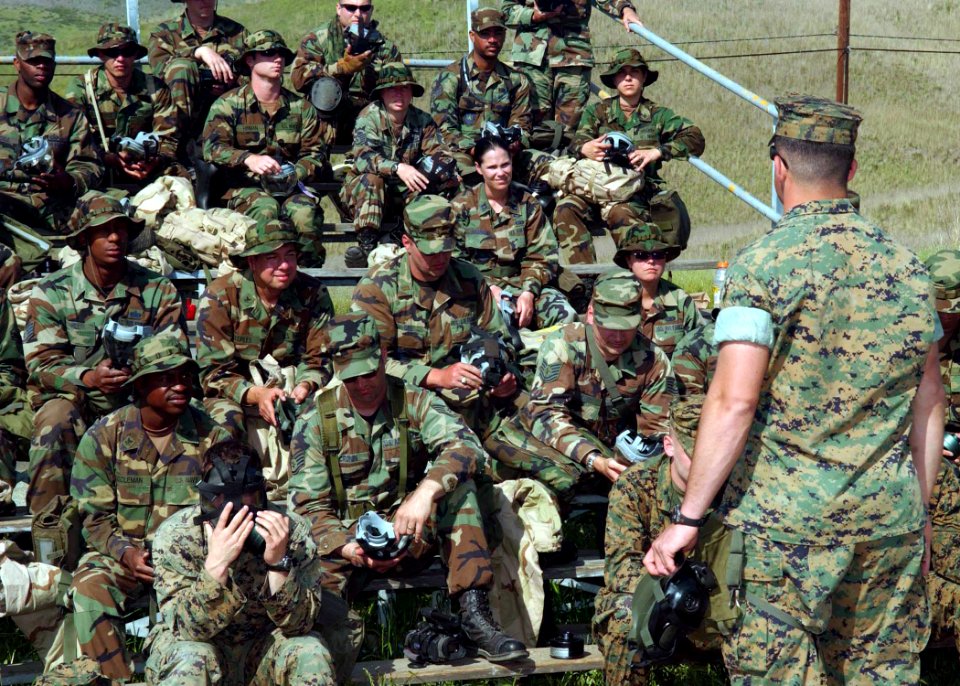US Navy 060420-F-0692M-071 U.S. Marine Corps Cpl. Michael Boscia a division instructor, shows how to properly assemble a gas mask during the Quick Shot 2006 field exercise