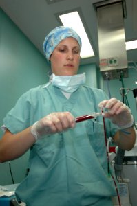 US Navy 060505-N-2832L-076 Hospital Corpsman Megan Beach, an anesthesiologist technician, practices checking the quality of the blood