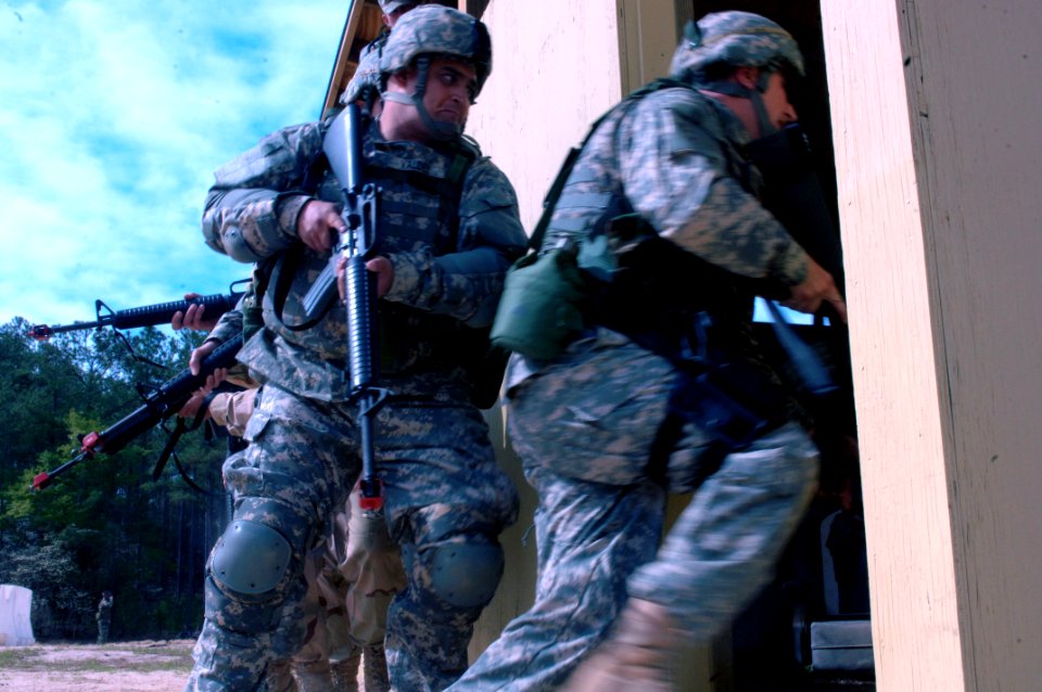 US Navy 060405-N-4097B-002 Sailors rush into a simulated building to conduct search and seizure operations during the Navy's Individual Augmentee Combat Training course at Fort Jackson, S.C