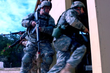 US Navy 060405-N-4097B-002 Sailors rush into a simulated building to conduct search and seizure operations during the Navy's Individual Augmentee Combat Training course at Fort Jackson, S.C