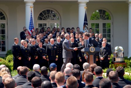 US Navy 060425-N-9909C-007 President George W. Bush shakes hands with the Navy football coach Paul Johnson during the official presentation of the Commander In Chief Trophy to the U.S Naval Academy football team at the White Ho