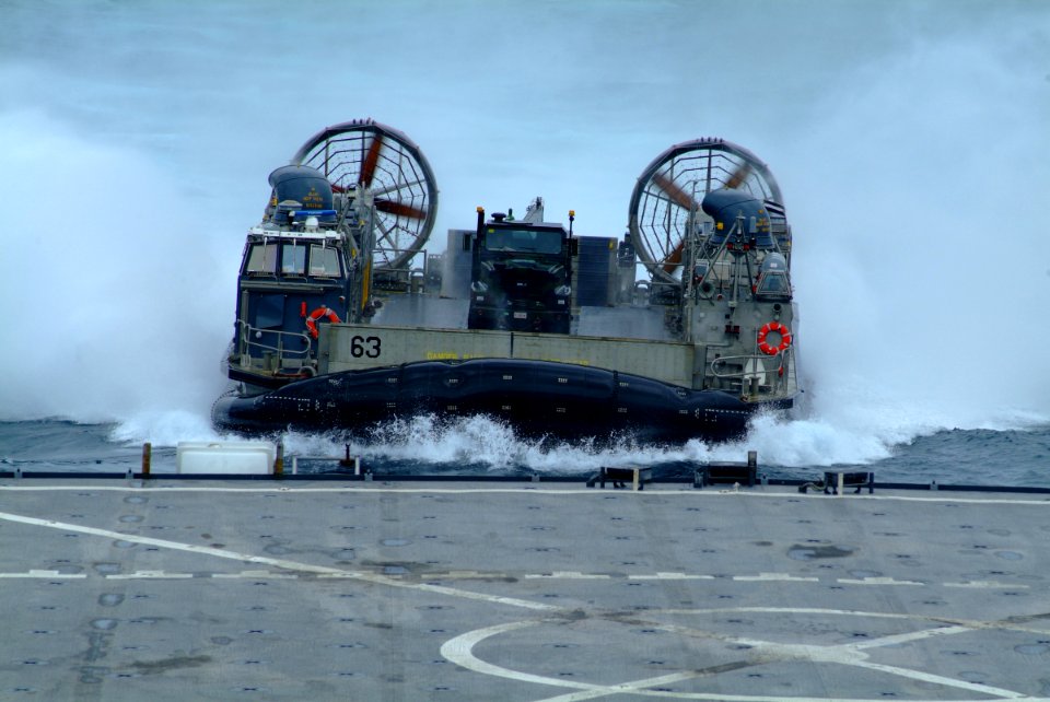 US Navy 060521-N-4772B-015 Landing Craft, Air Cushion Six Three (LCAC-63) from Assault Craft Unit Five (ACU-5) Detachment Western Pacific approaches the well deck of the amphibious dock landing ship USS Harpers Ferry (LSD 49) d