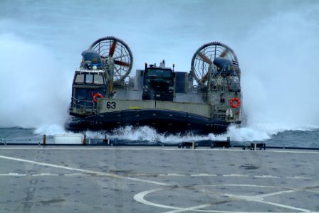 US Navy 060521-N-4772B-015 Landing Craft, Air Cushion Six Three (LCAC-63) from Assault Craft Unit Five (ACU-5) Detachment Western Pacific approaches the well deck of the amphibious dock landing ship USS Harpers Ferry (LSD 49) d