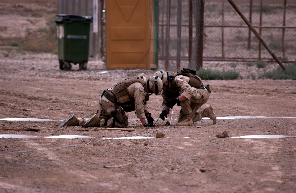 US Navy 060424-F-1424R-007 U.S. Navy Sailors assigned to Disposal Mobile Unit dig up a rocket