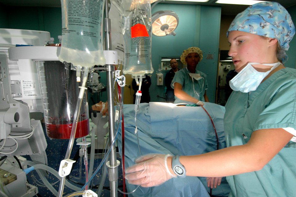 US Navy 060505-N-2832L-050 Hospital Corpsman Megan Beach, checks the flow of blood through a cell saver, during training for an antilogous blood transfusion