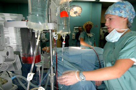 US Navy 060505-N-2832L-050 Hospital Corpsman Megan Beach, checks the flow of blood through a cell saver, during training for an antilogous blood transfusion