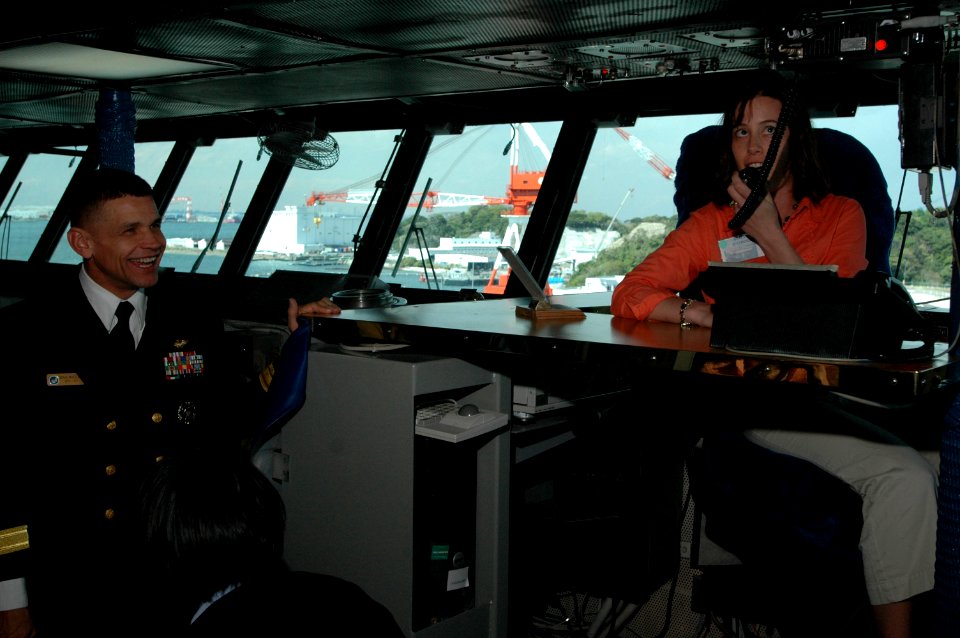 US Navy 060421-N-1332Y-034 Commander, Carrier Strike Group five (CSG-5), Rear Adm. Douglas McClain, conducts a tour of USS Kitty Hawk's (CV 63) navigation bridge for members of the Japanese American Wives Association