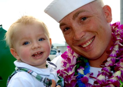 US Navy 060525-N-9643K-010 A Sailor poses with his son as the guided-missile destroyer USS Chung-Hoon (DDG 93) returns to Pearl Harbor after a four-month maiden deployment