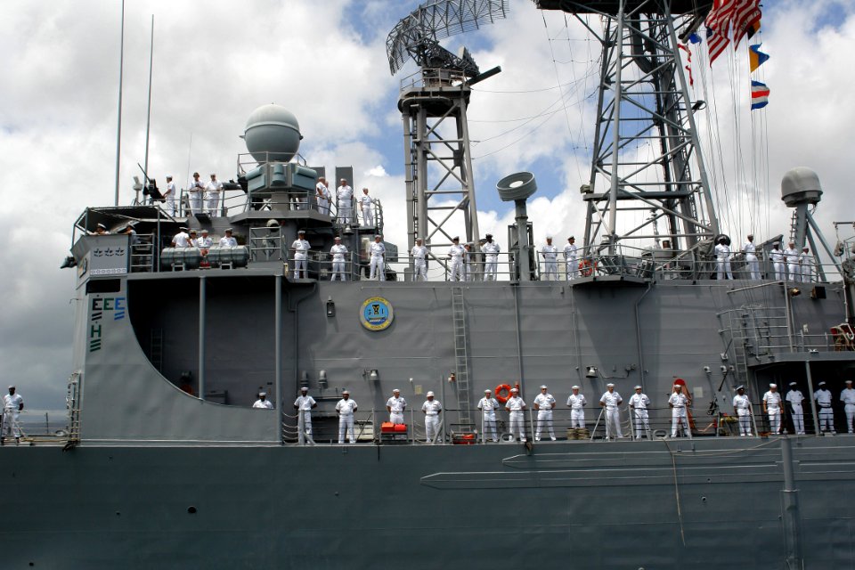 US Navy 060505-N-9643K-027 Sailors man the rails as the guided-missile frigate USS Crommelin (FFG 37) departs Pearl Harbor for a four-month cruise to the U.S. Navy's 7th Fleet area of operation