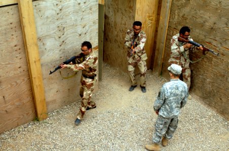 US Navy 060412-N-4614W-044 Iraq Army soldiers from a 5th Battalion search through a kill house, as Army Spc. Nate Wagar observes, during military operations in urban terrain (MOUT)