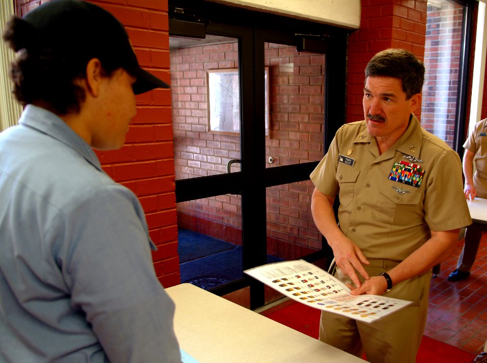 US Navy 060518-N-0962S-072 Master Chief Petty Officer of the Navy (MCPON) Terry Scott quizzes a student standing quarterdeck watch on Navy officer and enlisted pay grades