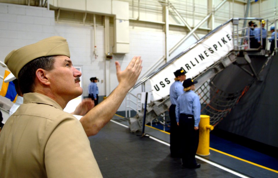 US Navy 060518-N-0962S-183 Master Chief Petty Officer of the Navy (MCPON) Terry Scott looks on as some of the Navy's newest Sailors handle lines about the USS Marlinspike on board Recruit Training Command (RTC) Great Lakes