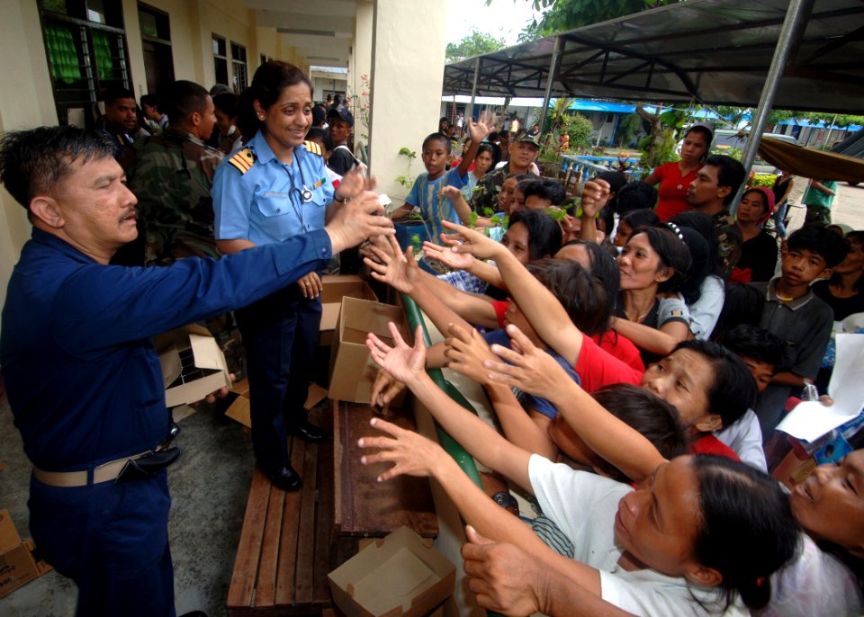 US Navy 060528-N-8391L-240 U.S. Navy Cmdr. Henry Villareal, executive officer of Military Sealift Command (MSC) hospital ship USNS Mercy (T-AH 19), gives away free hygienic products to residents of Zamboanga at the local Recodo