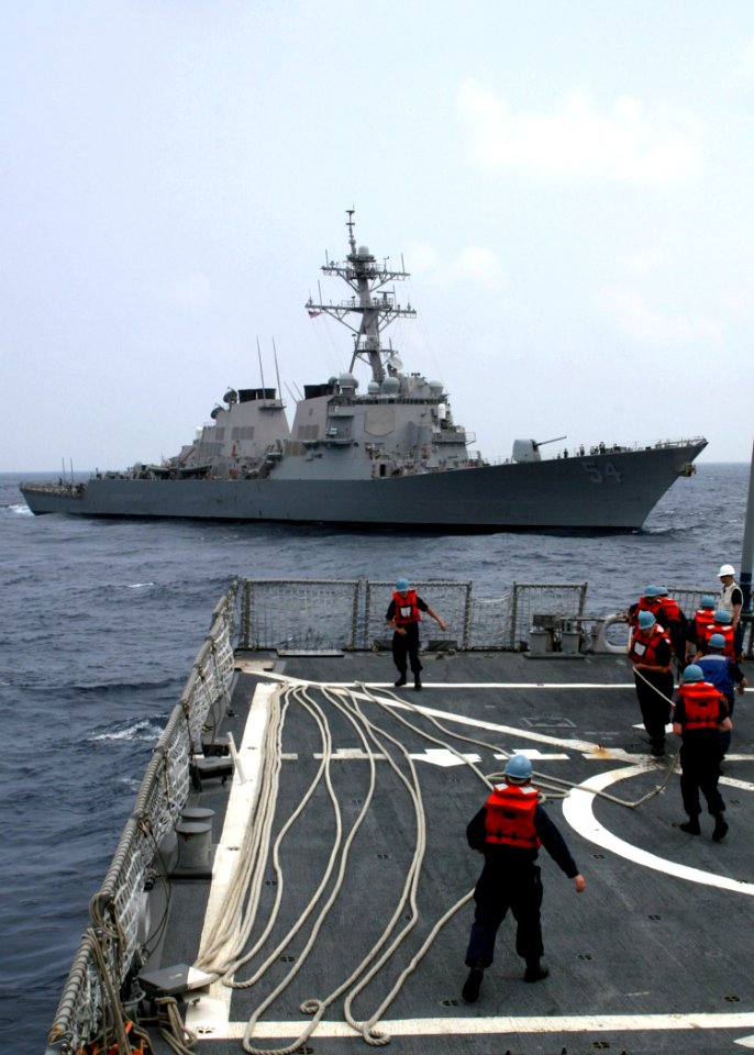 US Navy 060504-N-4953E-010 Boatswain's mates heave lines as the guided-missile destroyer USS Stethem (DDG 63) prepares to tow the guided-missile destroyer USS Curtis Wilbur (DDG 54) during a towing exercise (TOWEX)