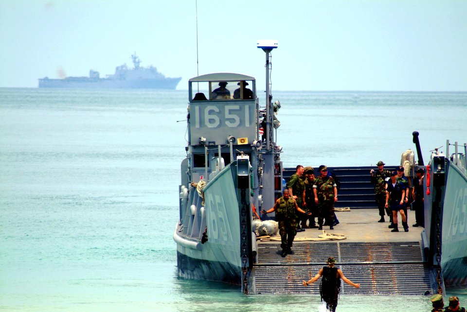 US Navy 060515-N-4772B-389 With the amphibious dock landing ship USS Harpers Ferry (LSD 49) in the background, Landing Craft Utility One Six Five One (LCU-1651) assigned to Assault Craft Unit One, (ACU-1) Detachment Western Pac