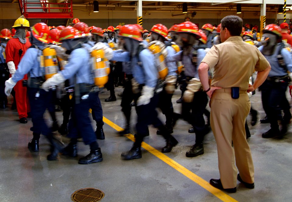 US Navy 060518-N-0962S-151 Master Chief Petty Officer of the Navy (MCPON) Terry Scott looks on as some of the Navy's newest Sailors receive firefighting training on board Recruit Training Command (RTC) Great Lakes