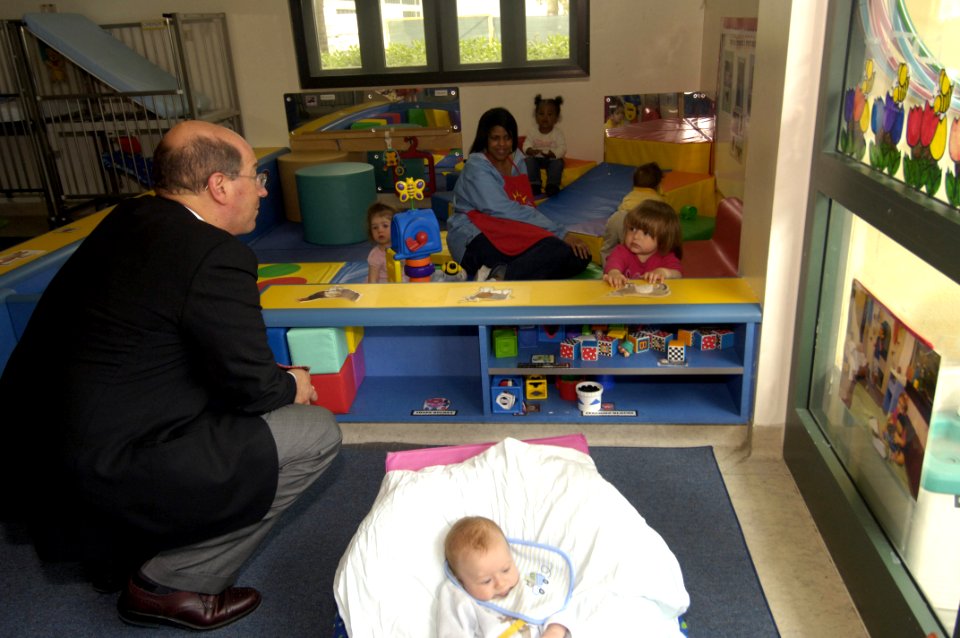 US Navy 060421-N-2568S-074 Secretary of the Navy (SECNAV) the Honorable Dr. Donald C. Winter visits with children at the Child Development Center at Naval Support Activity Naples, Italy