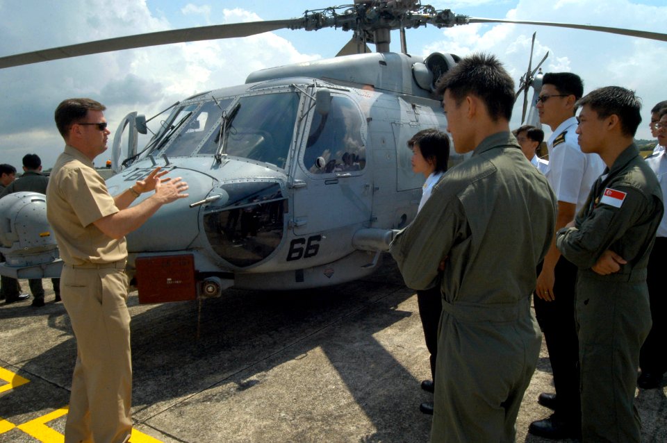 US Navy 060601-N-4205W-004 Officer in Charge Anti-Submarine Squadron Light Three Seven (HSL-37) Detachment 5, Lt. Cmdr. Colin Smith, explains the capabilities of the SH-60B Seahawk helicopter