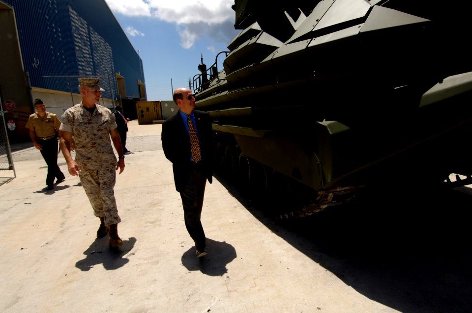 US Navy 060602-N-3642E-007 Secretary of the Navy (SECNAV) the Honorable Dr. Donald C. Winter inspects an amphibious assault vehicle (AAV) while Col. Jim Hooks (left) briefs the SECNAV on the Maritime Pre-positioning Ships maint