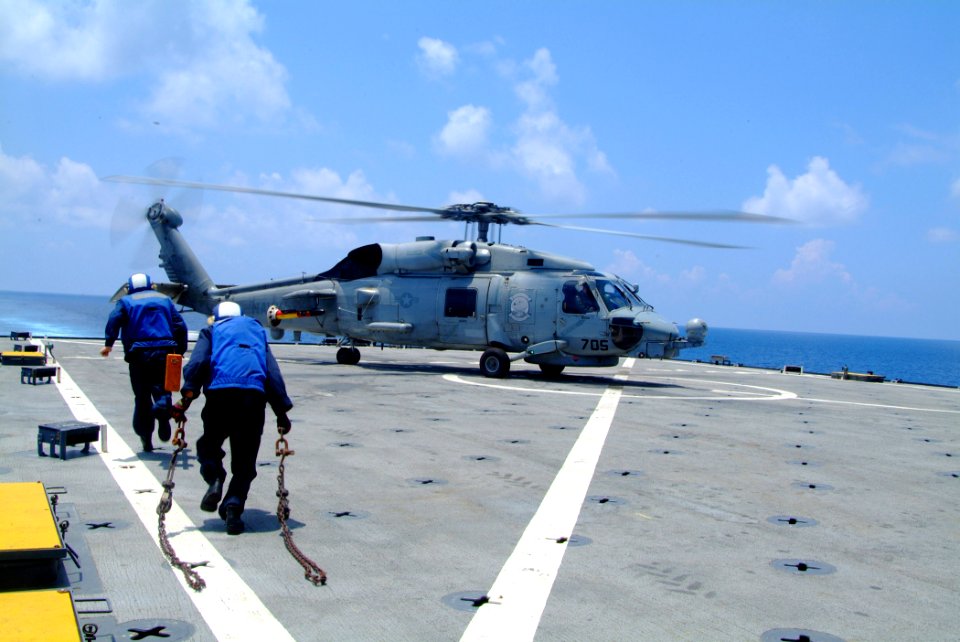 US Navy 060510-N-4772B-019 Flight deck personnel rush to tie down an SH-60B Seahawk helicopter assigned to the Saberhawks of Anti Submarine Squadron Light Four Seven (HSL-47)