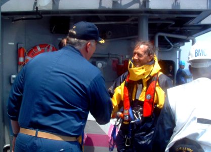 US Navy 060522-N-0170L-001 The Commanding Officer of the guided-missile cruiser USS Vella Gulf (CG 72), Capt. Steve Davis welcomes Mr. Johan Aarden safely aboard photo