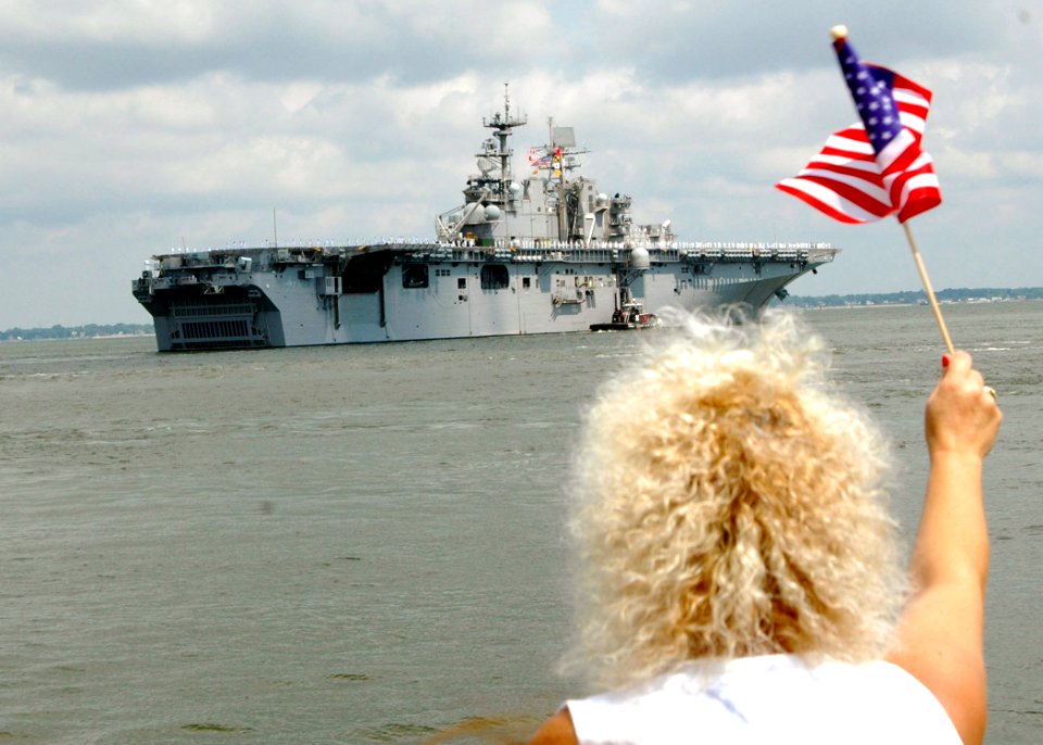 US Navy 060606-N-2248M-002 Families wave goodbye as the Sailors aboard the amphibious transport ship USS Nashville (LPD 13) and the amphibious assault ship USS Iwo Jima (LHD 7) departs Naval Station Norfolk
