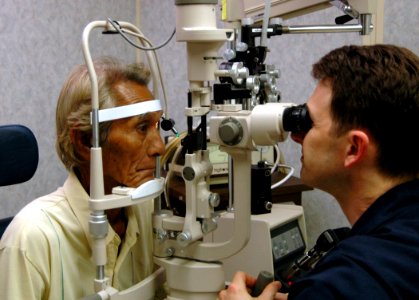 US Navy 060526-N-3532C-058 U.S. Navy Ophthalmologist, Cdr. Jason Ross, conducts an eye exam for a local resident aboard Military Sealift Command hospital ship USNS Mercy photo