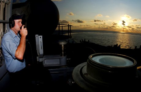 US Navy 060607-N-7526R-224 Seaman Jason Smith, communicates with the Nimitz-class aircraft carrier USS Ronald Reagan (CVN 76) bridge while standing the port, aft look out watch photo