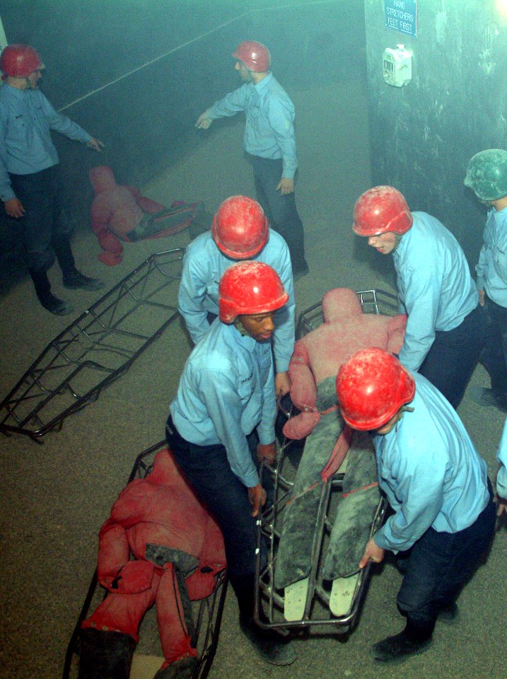 US Navy 060519-N-0962S-005 Sailors in their final week of training at Recruit Training Command (RTC) Great Lakes attempt to move sandbags simulating injured personnel through smoke and other obstacles during their Battle Statio