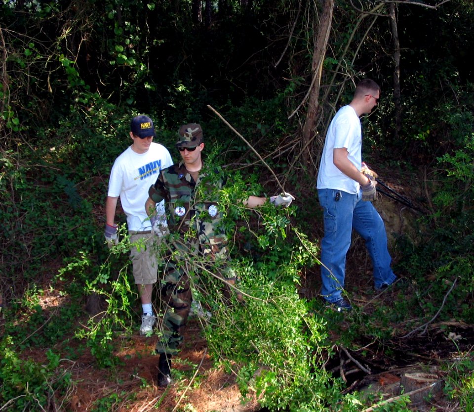 US Navy 060525-N-5324B-002 11 volunteers helping the Little Rock Parks and Recreation Department clear heavy brush at Connor Park in preparation for repairs to the levee of a 4 acre lake