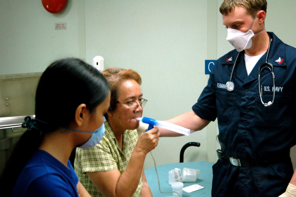 US Navy 060528-N-3532C-028 Hospital Corpsman 2nd Class Ian Flemming-Dunn tests a local resident for tuberculosis aboard U.S. Military Sealift Command (MSC) hospital ship, USNS Mercy (T-AH 19) while visiting the city providing h