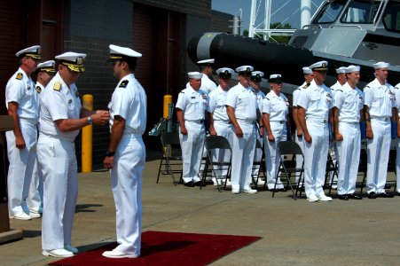 US Navy 060526-N-0635C-084 Rear Adm. Donald Bullard, commander, Navy Expeditionary Combat Command presents the Silver Star with Combat Distinguishing Device to Chief Warrant Officer Two William A. Bastable