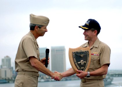 US Navy 060608-N-3349L-846 Commander, Naval Air Forces Pacific, Vice Adm. James Zortman presents USS Nimitz (CVN 68) Commanding Officer Capt. Ted Branch with the 2005 Battle E Award