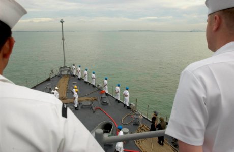 US Navy 060529-N-9851B-002 Sailors man the rails of amphibious dock landing ship USS Tortuga (LSD 46) as she pulls into Changi Naval Base, Singapore