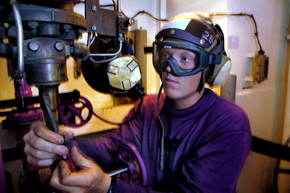 US Navy 060530-N-3946H-076 Aviation Boatswain's Mate (Fuels) Airman Joshua Hinck changes the diaphragm of the de-fueling pressure relief valve in Aviation Fuel Station 24 aboard USS Kitty Hawk (CV 63)