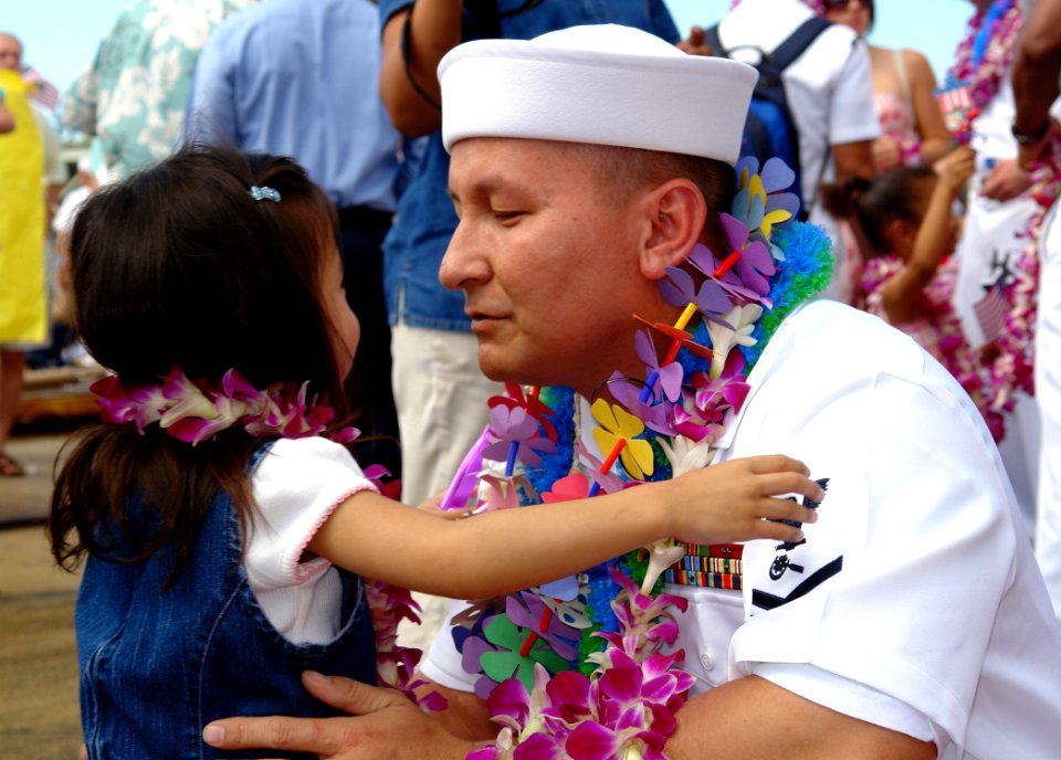 US Navy 060525-N-9643K-006 A Sailor greets his daughter on the pier following the return of the guided-missile destroyer USS Chung-Hoon (DDG 93) to Pearl Harbor after a four-month maiden deployment