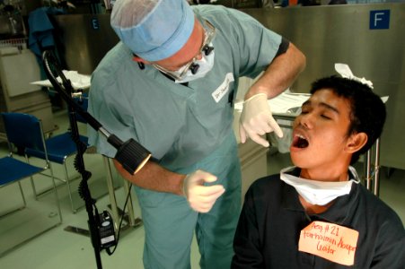 US Navy 060607-N-2832L-042 Air Force Col. Jeffrey Swartz, a dentist from Smithtown N.Y., pulls teeth from patients aboard the U.S. Military Sealift Command (MSC) Hospital ship USNS Mercy (T-AH 19)