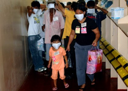 US Navy 060614-N-9076B-162 Patients don mask and began their walk up a ramp to medical treatment facilities the U.S. Military Sealift Command (MSC) Hospital Ship USNS Mercy (T-AH 19)